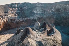 Lions on a large rock formation representing the volcanic nature of Ol Donyo Lengai